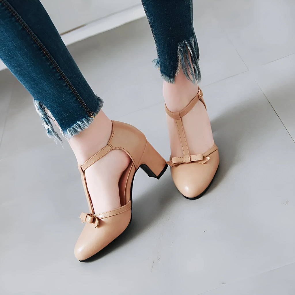 Women's apricot chunky heel sandals with hollow out design, bow tie, and a single buckle strap.