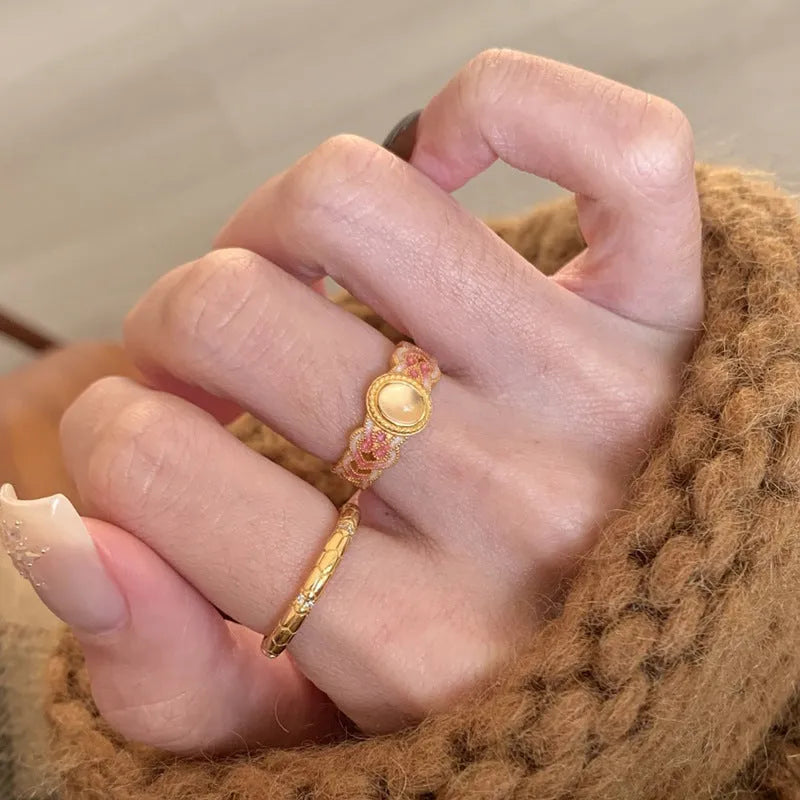 Pink crystal enamel geometric open ring on a gold plated copper band for women.