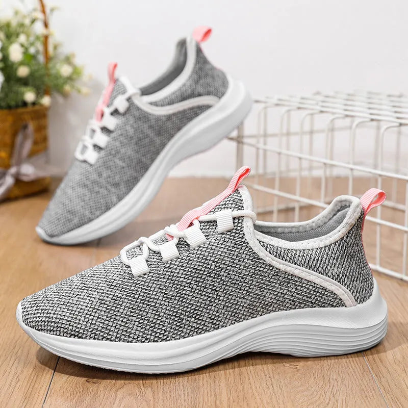 Women's low-top mesh sneakers in black, grey, or pink with breathable flyknit design and EVA sole