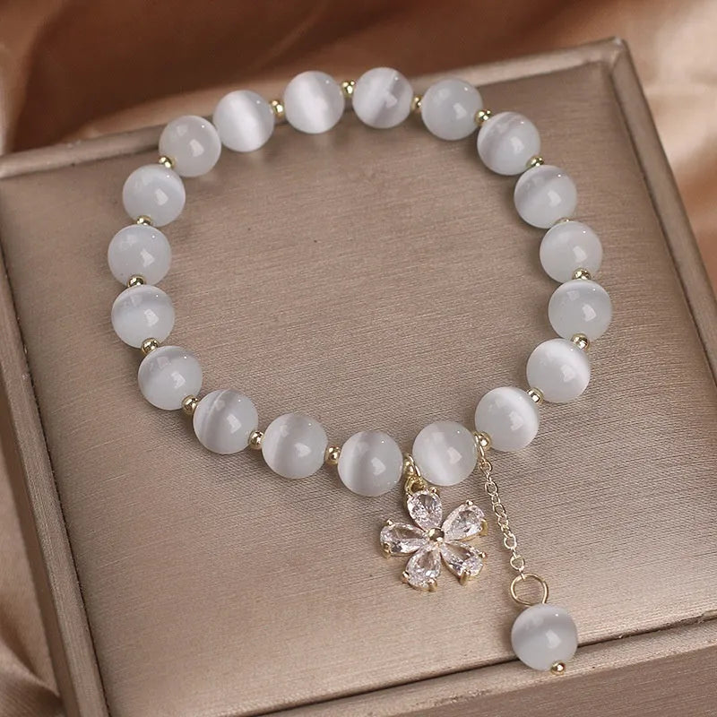 Women's white cat's eye crystal bracelet with flower tassels and morganite safety buckle pendant