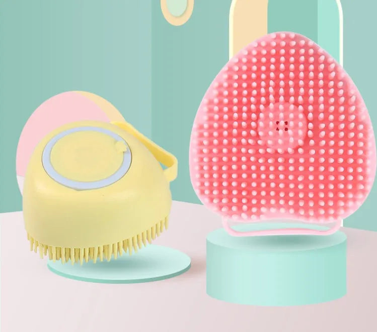 Blue silicone dog bath brush with soft bristles, shown on a hand.