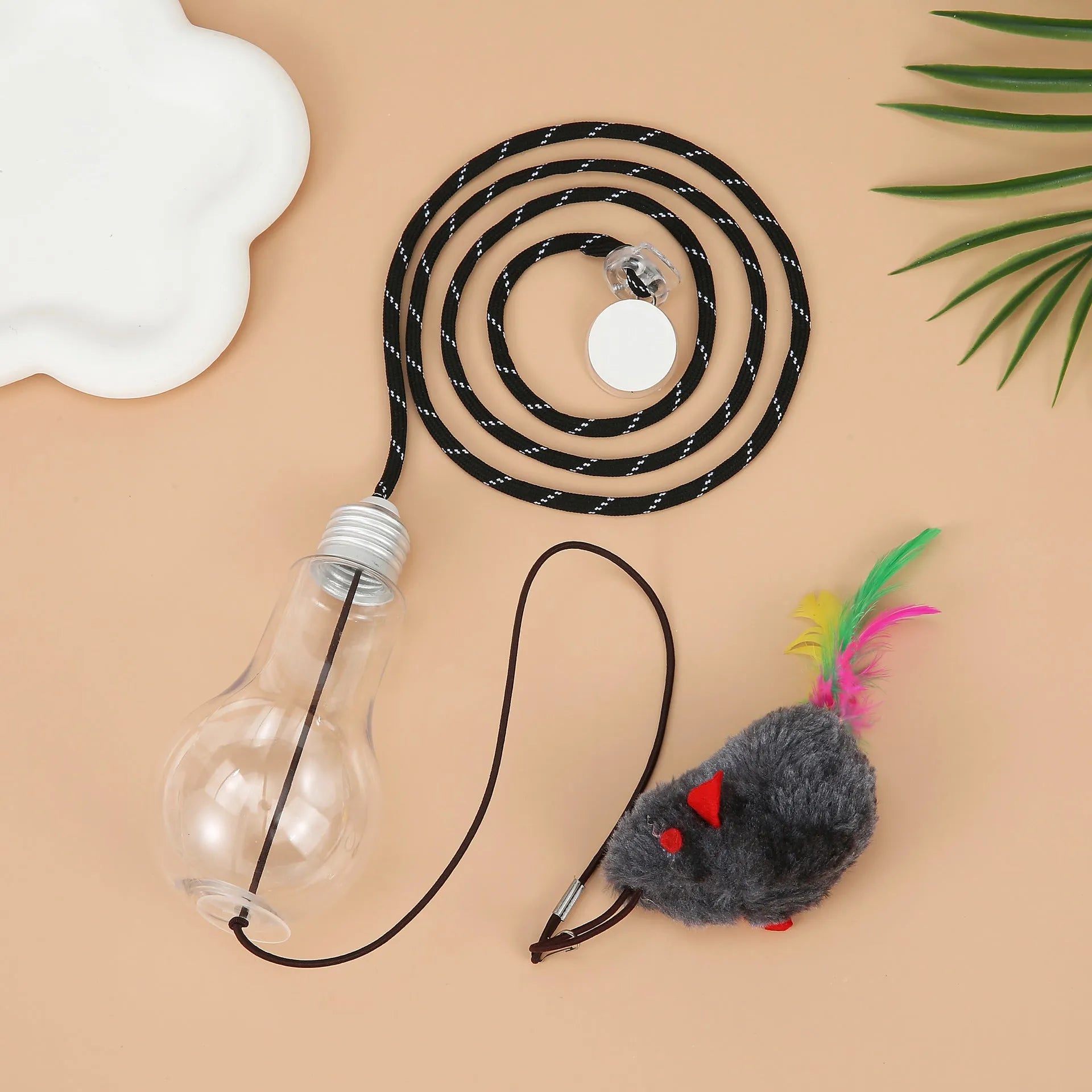 Interactive cat toy hanging on door frame with treat bulb and dangling mouse toy on elastic rope