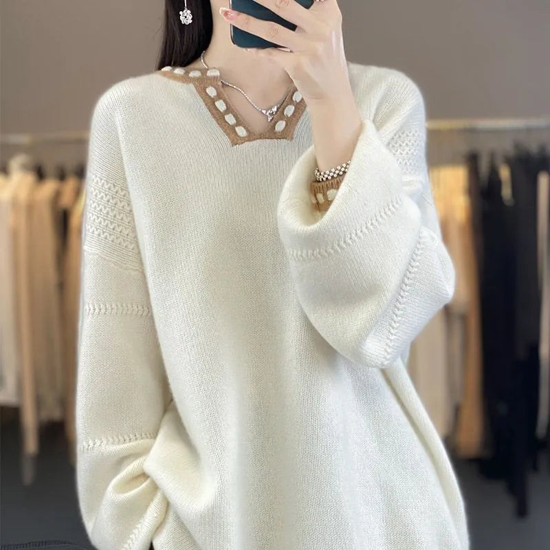 Women's camel coloured V-neck pullover sweater with long sleeves on a hanger.