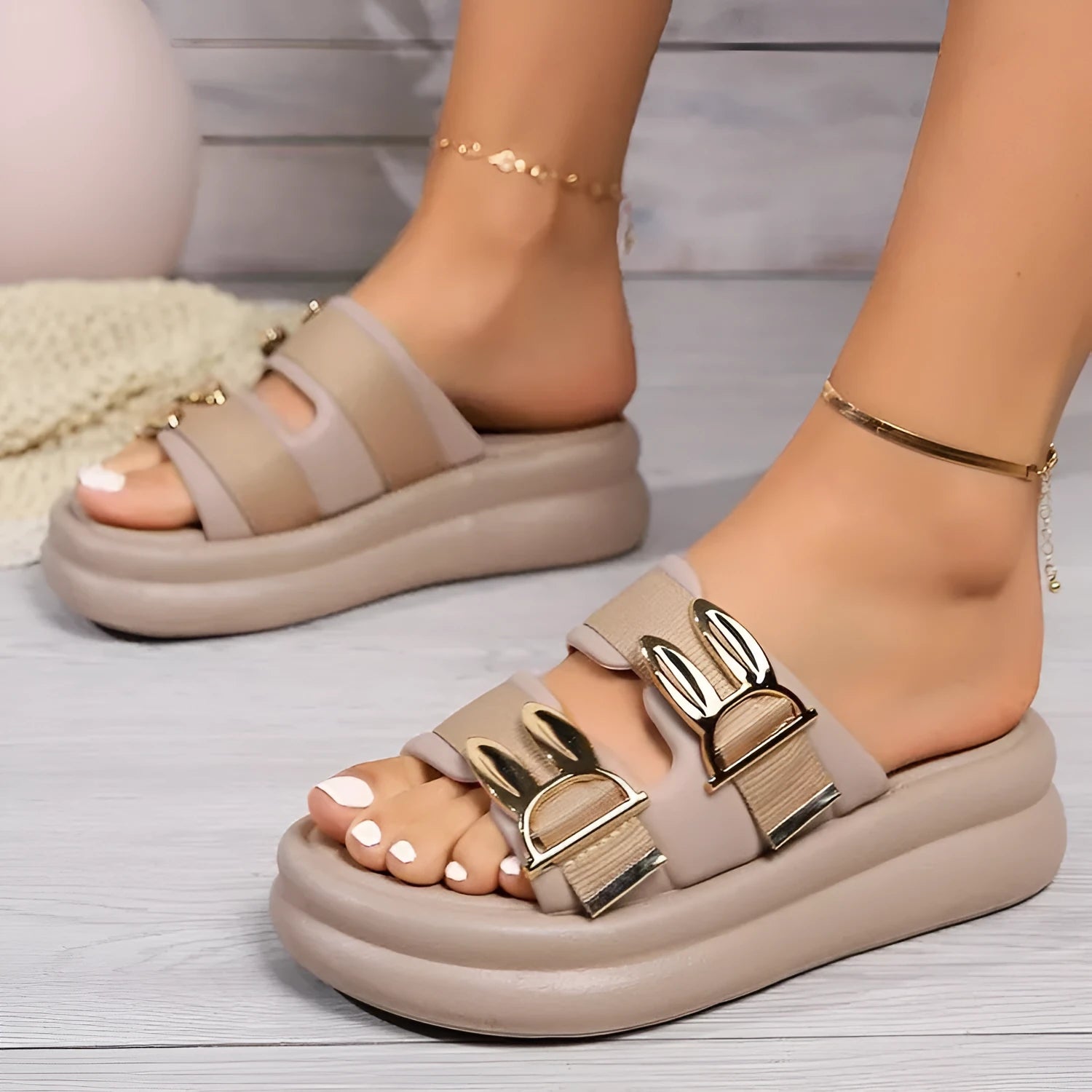 Women's suede slippers in apricot colour with a thick rubber sole.