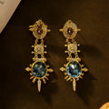 A pair of gold-coloured geometric round stud earrings with a retro style and diamond-treated alloy finish.