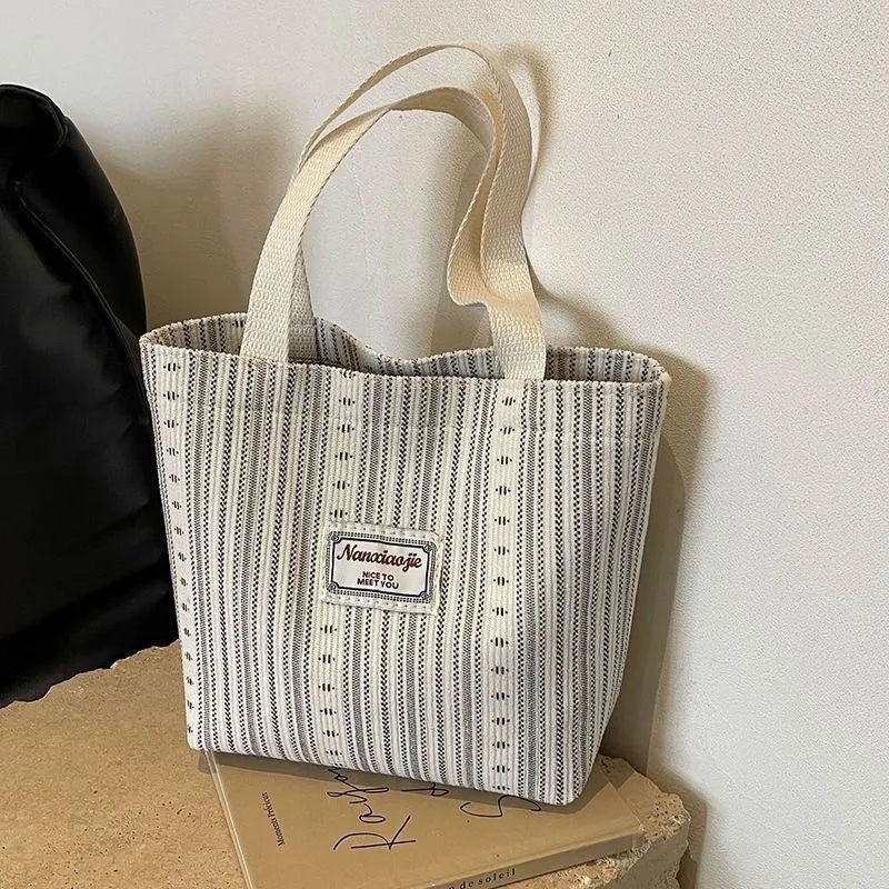 Japanese style corduroy shoulder bag in dark brown colour showing textured fabric and large main compartment