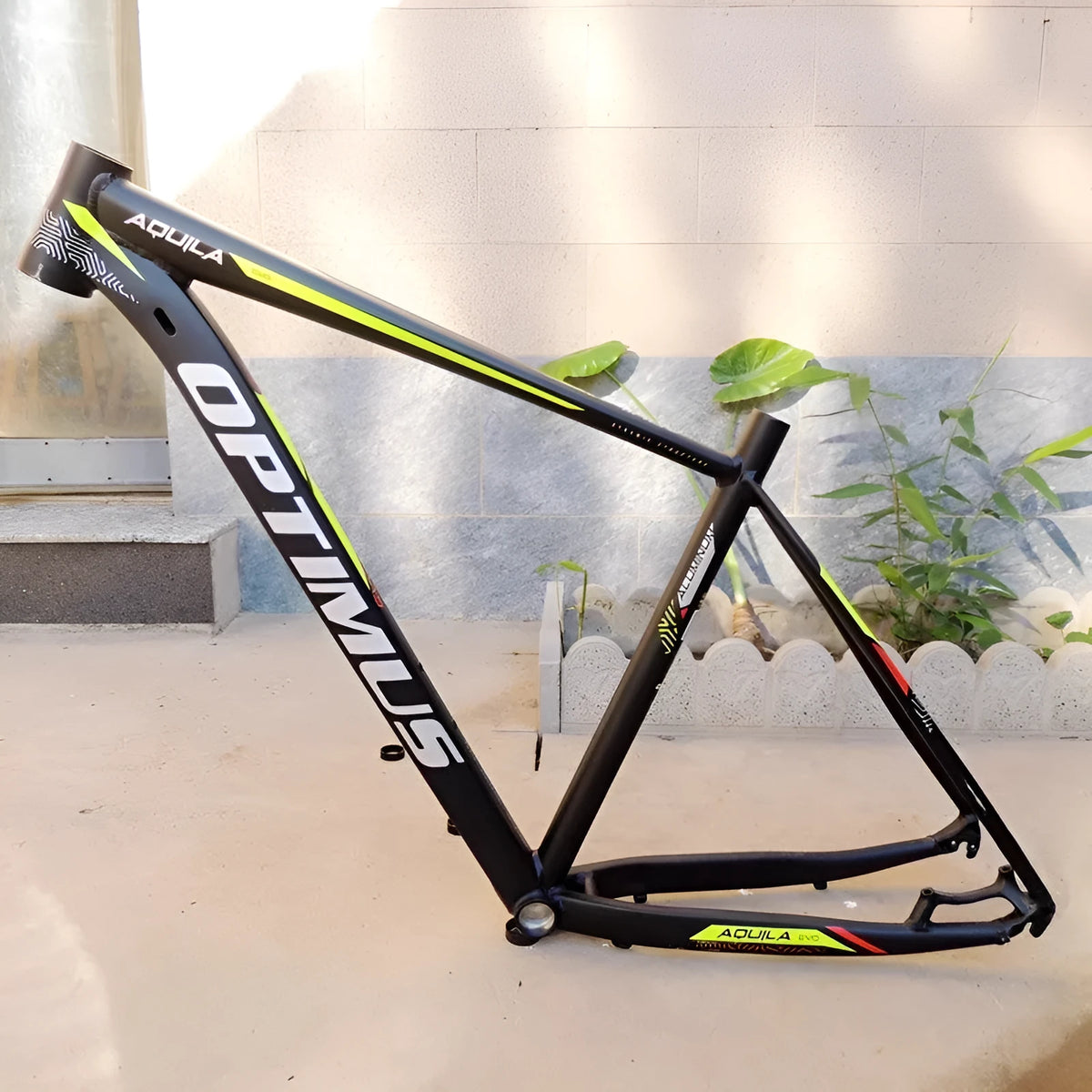 Black green aluminium mountain bike frame showing disc brake mount and internal cable routing ports