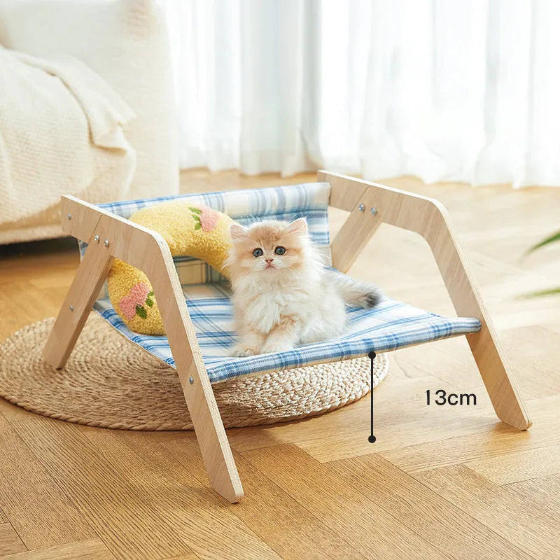 Wooden elevated cat bed with blue cloth hammock for indoor feline lounging