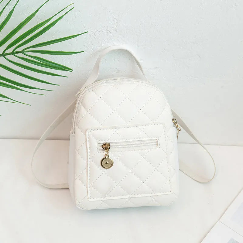 Girls' hard backpack with embroidery in white, black, or pink colours, showing sandwich pocket and soft handle