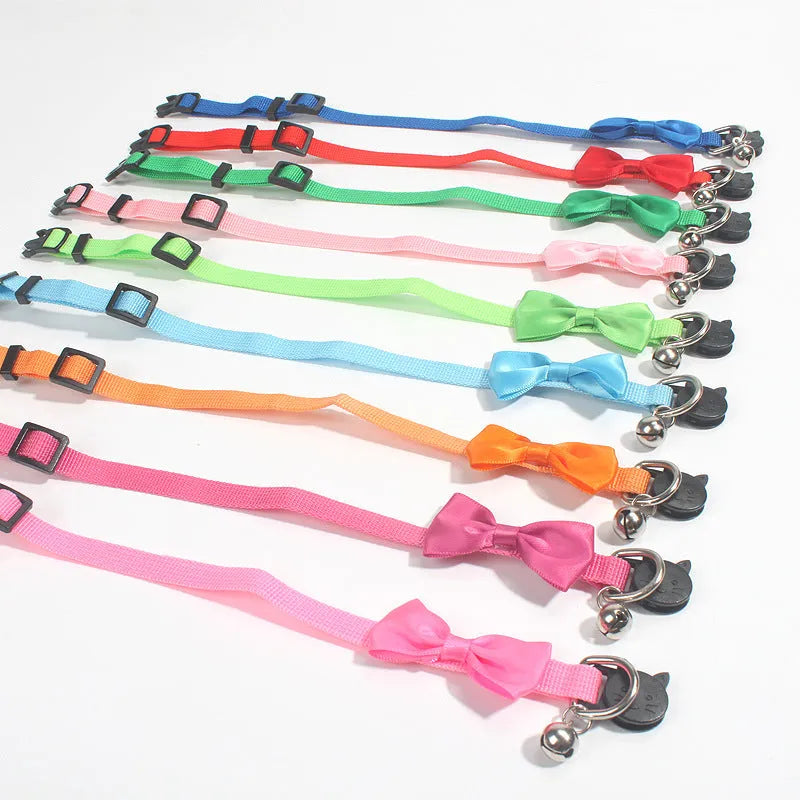 Adjustable striped nylon cat collar with bell in various colors including red, green, and blue