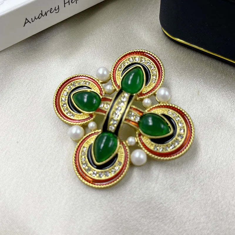 Classic vintage zinc alloy brooch with baroque-style cross design and crystal details on a dark background.