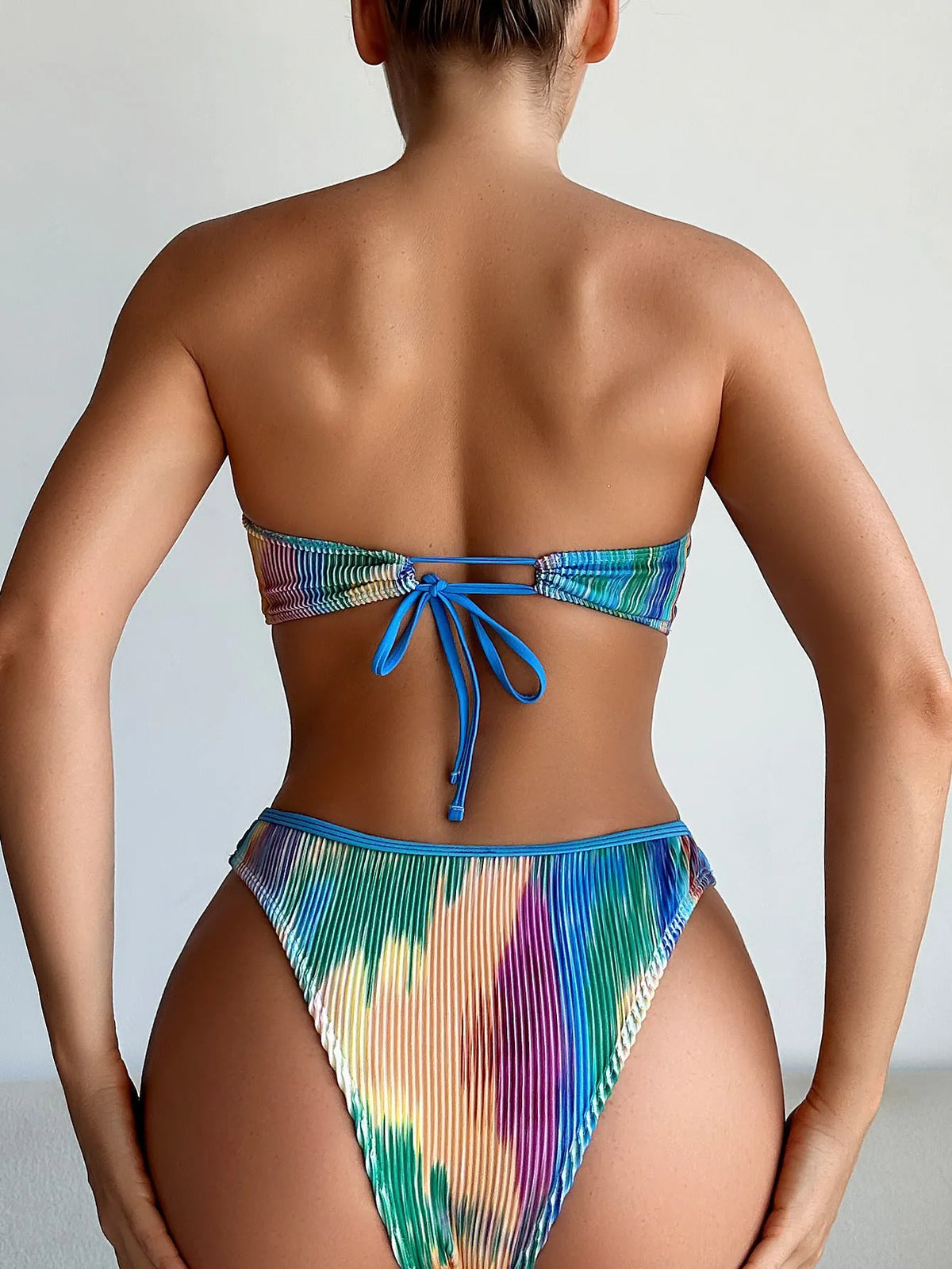 Women's colour printed tube top bikini set with solid briefs on a mannequin.