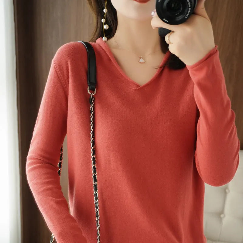 Women's V-neck long sleeve knit top in a macaron colour on a hanger.