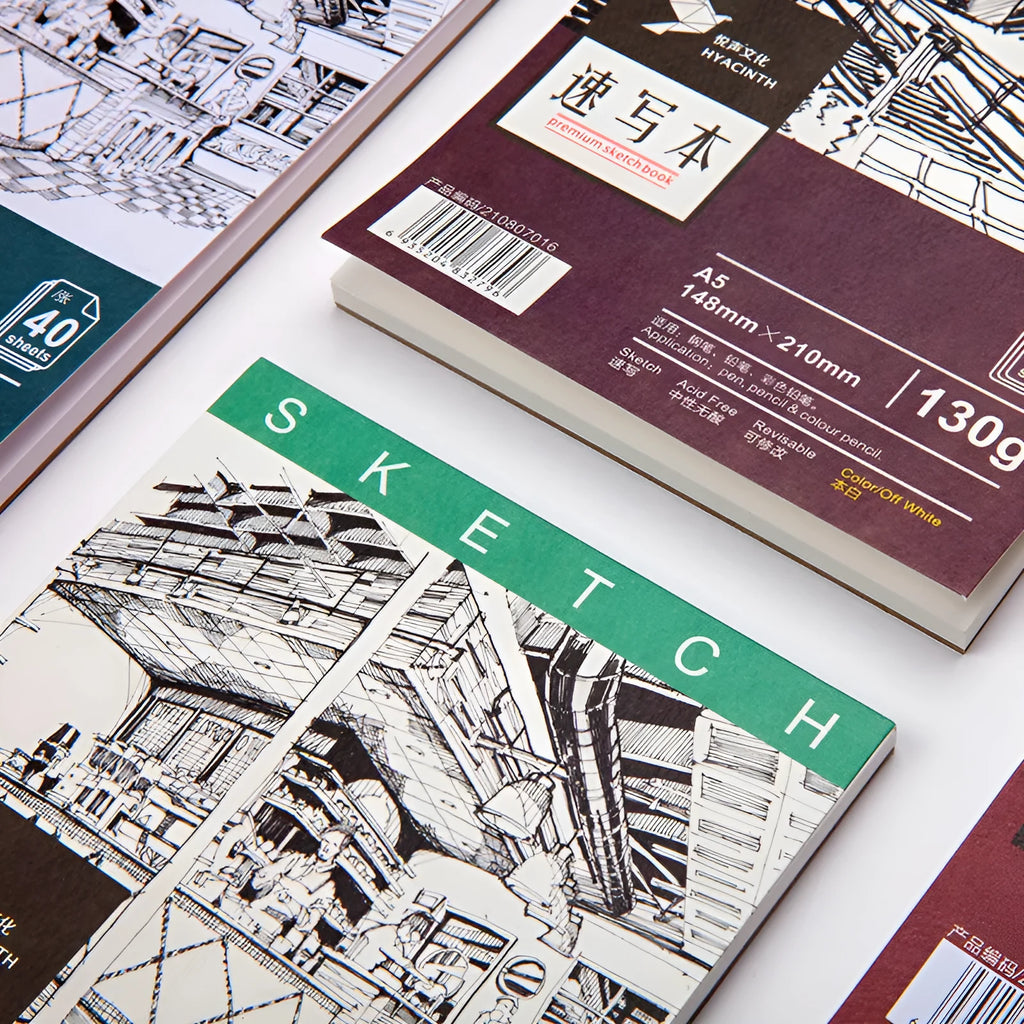 A4 sketchbook with coil binding showing vertical page turning capability alongside A3 glue-bound sketch pack