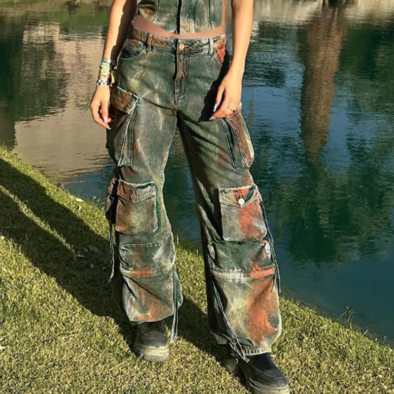 Loose blue denim cargo trousers with multiple gradient colour pockets and decorative stitching.