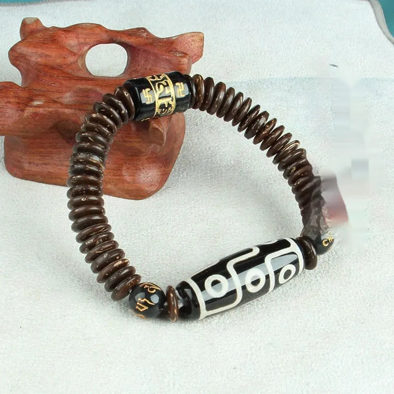 Distressed agate bracelet with traditional Tibetan dzi beads including three-eye and Nine Eyes designs.