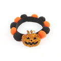 Halloween pet collar with decorative fur ball in pumpkin, bow, skull, and witch designs