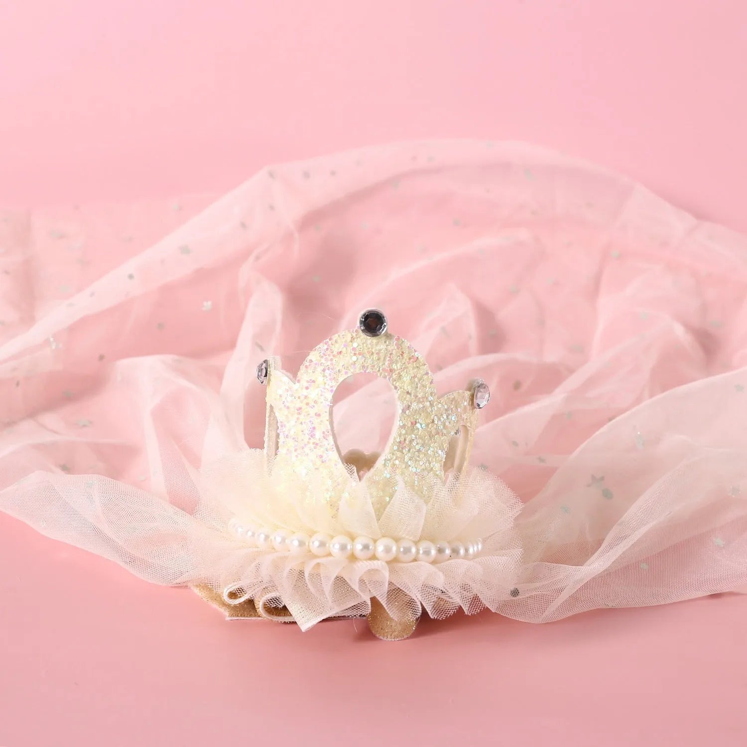 Beige and pink Princess crown veil headdress for a cat on a mannequin head.