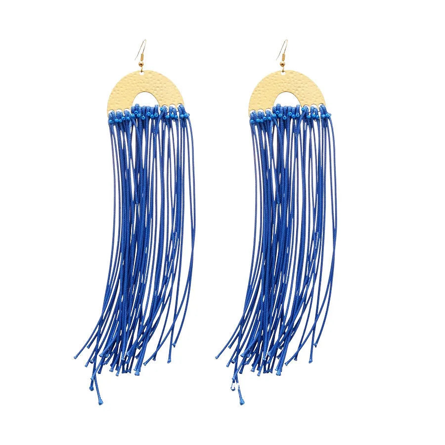 Women's geometric earrings with blue resin flower and silver needle on cloth background