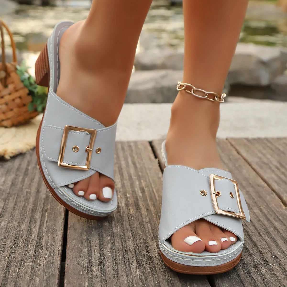 Women's black chunky heel beach slippers with metal buckle detail on round toe design