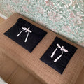 Women's black quilted laptop bag with ballet bow detail and striped pattern