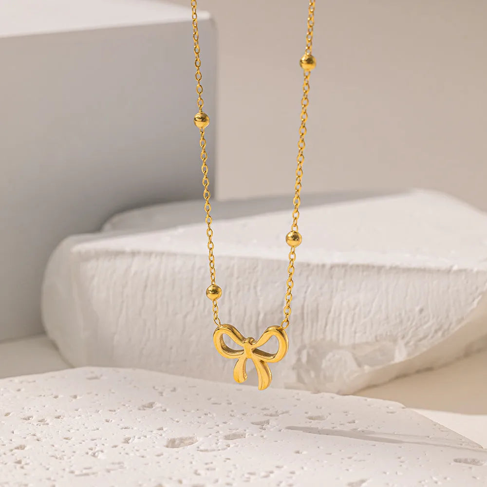 Gold bow necklace on cross chain with adjustable 41-50cm length