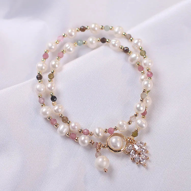 Women's double layer crystal bracelet with lucky cat charm and red cat's eye flower beads.