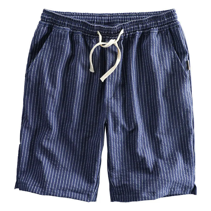Man wearing striped casual cotton shorts with a loose straight fit and elasticated mid waist.