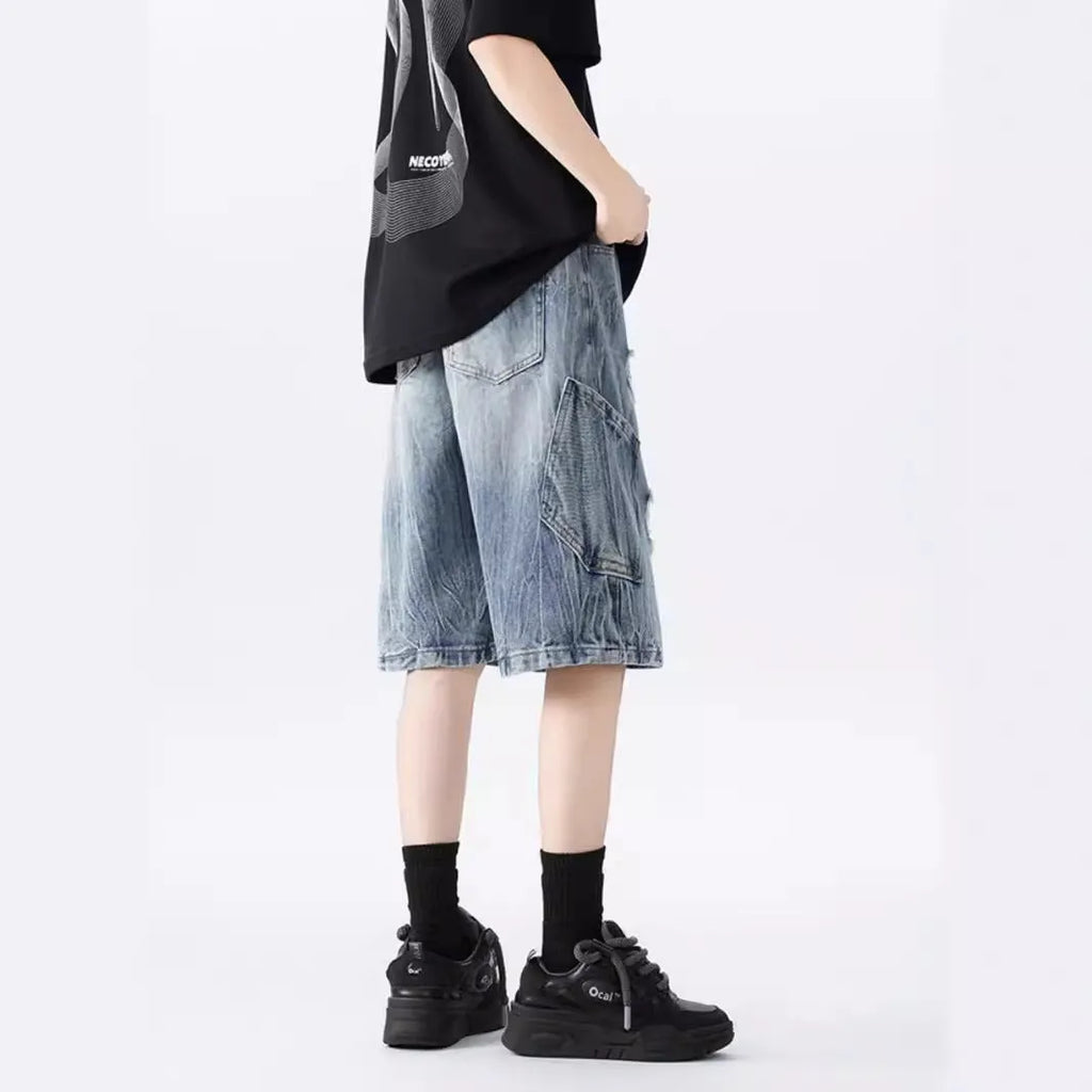 Retro loose fit denim shorts with washed and ripped detailing in blue and black colours