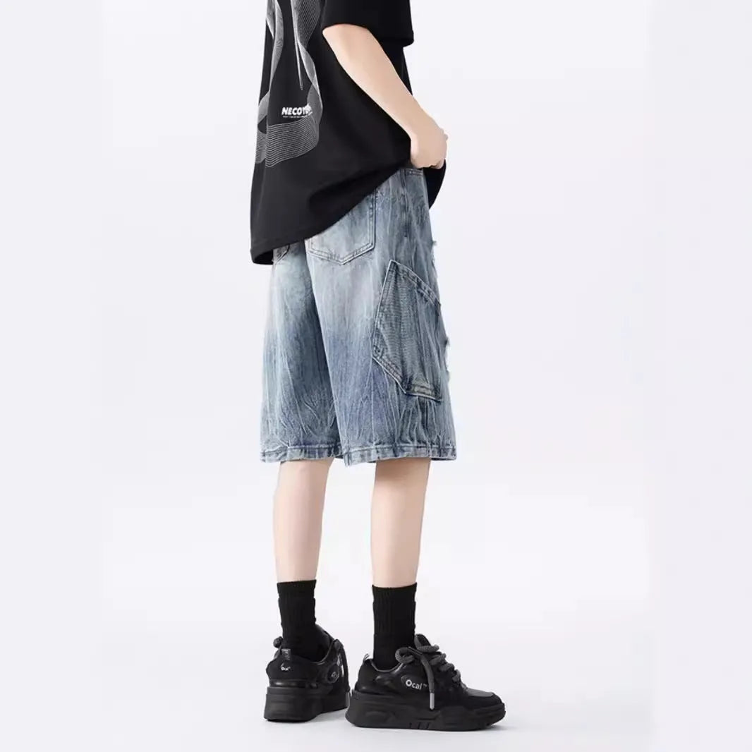 Retro loose fit denim shorts with washed and ripped detailing in blue and black colours