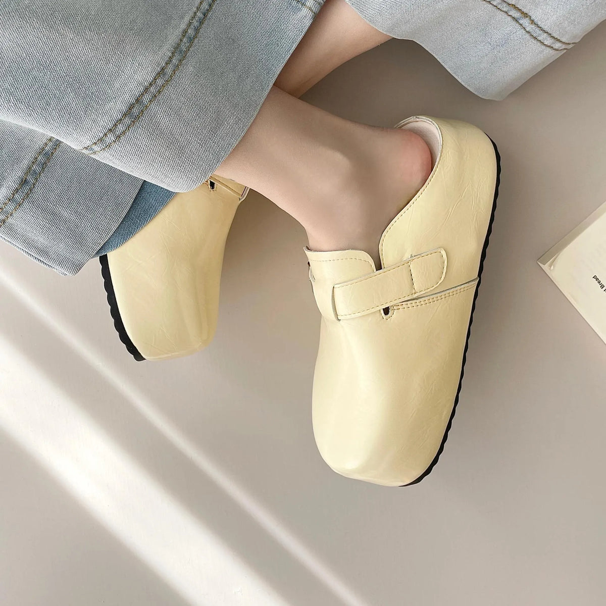 Casual flat buckle sneakers in yellow with round toe, shown on a white background.