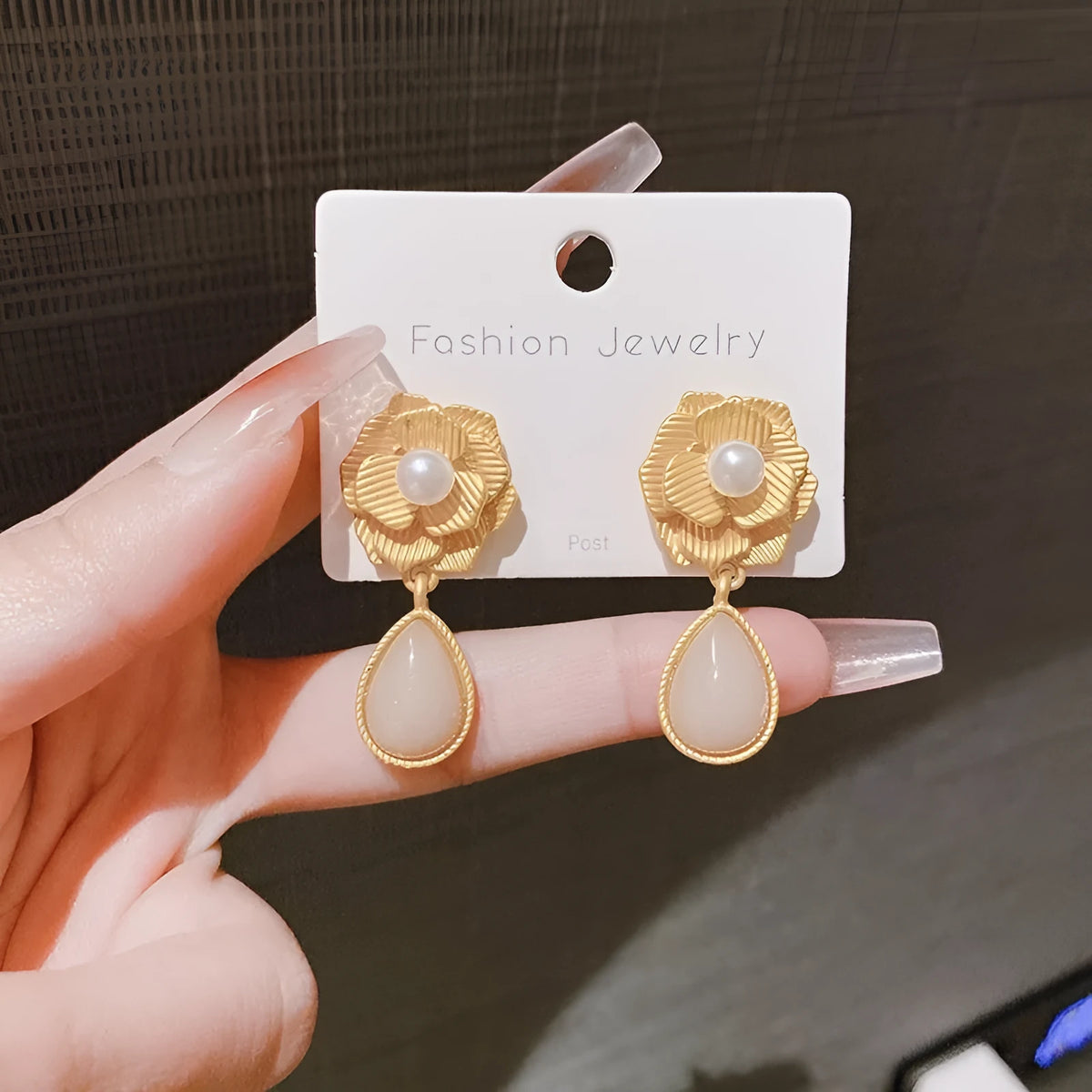 Gold floral stud earrings with rose pearl design, ice flower details, and a central opal stone.