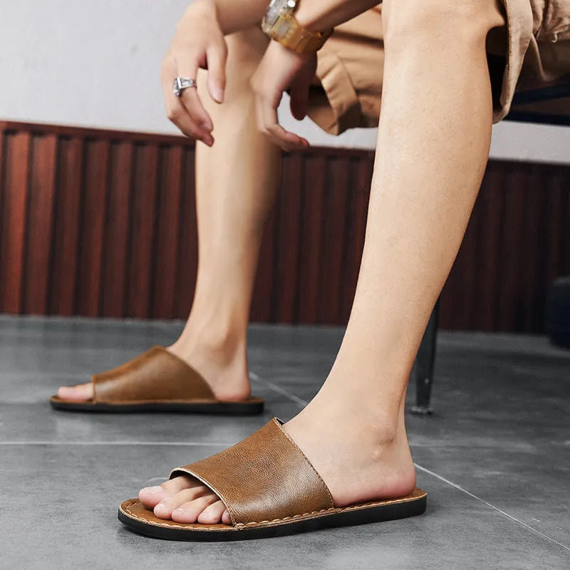 Brown leather men's open-toe sandals with a rubber sole on a neutral background.
