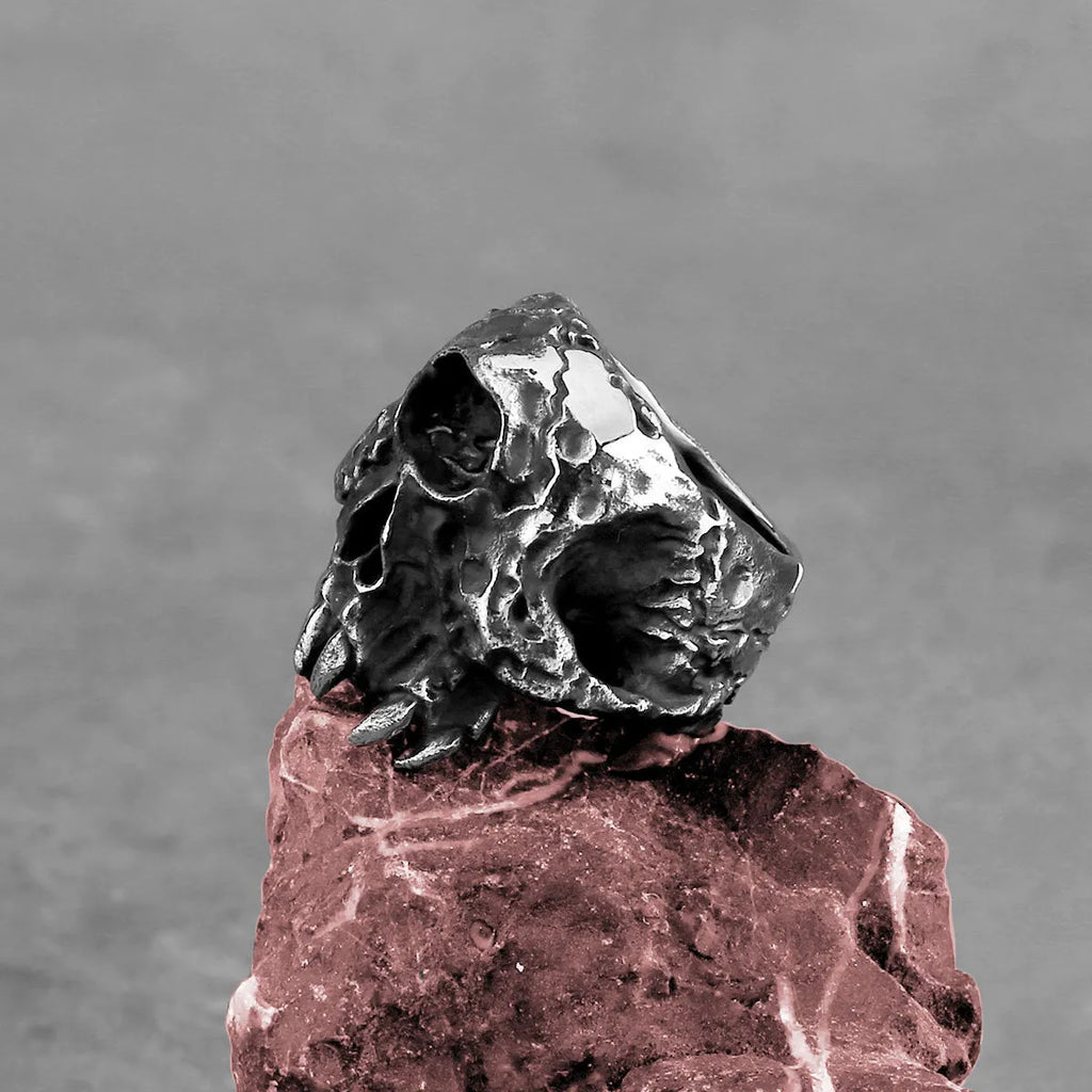 Silver alloy one-eyed skull ring with electroplated finish available in sizes 7 to 13