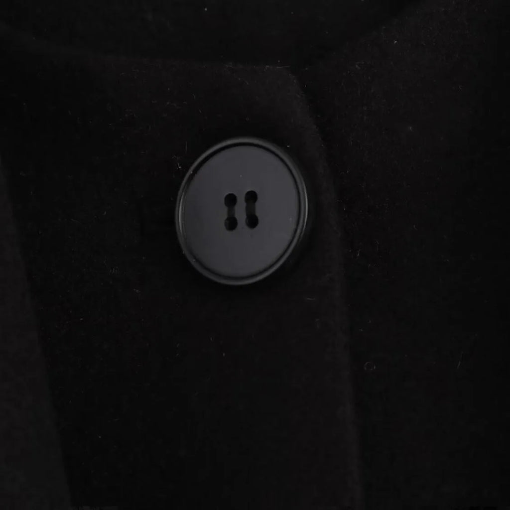 Women's long grey coat with artificial fur collar, shown with pockets and street-fashion styling.