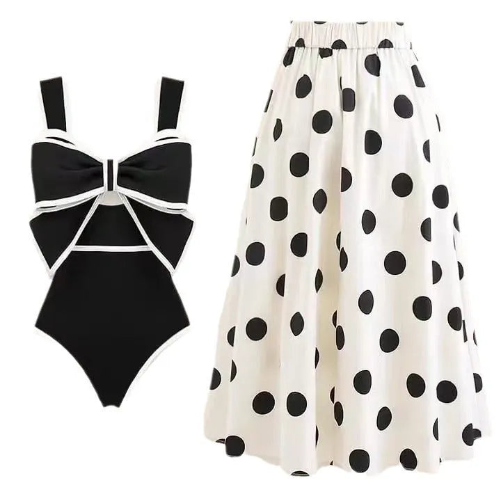 Women's black one-piece swimsuit with white bow and attached round skirt