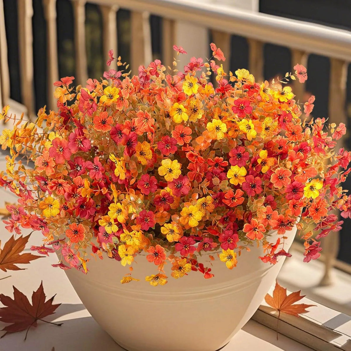 Artificial flower bouquet in autumn orange, red, and yellow colours for home and event decoration.