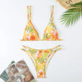 Women's blue halter top and matching briefs swimsuit set with floral pattern on a mannequin.