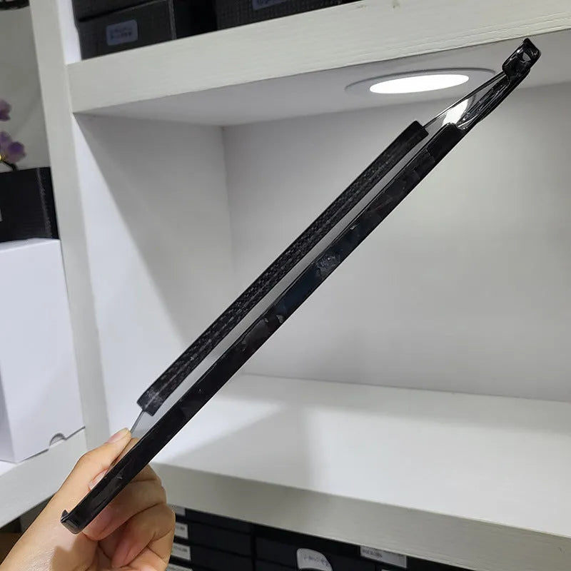 Carbon fibre hard case for Apple iPad Pro 11 showing embossed plaid pattern and matte finish.