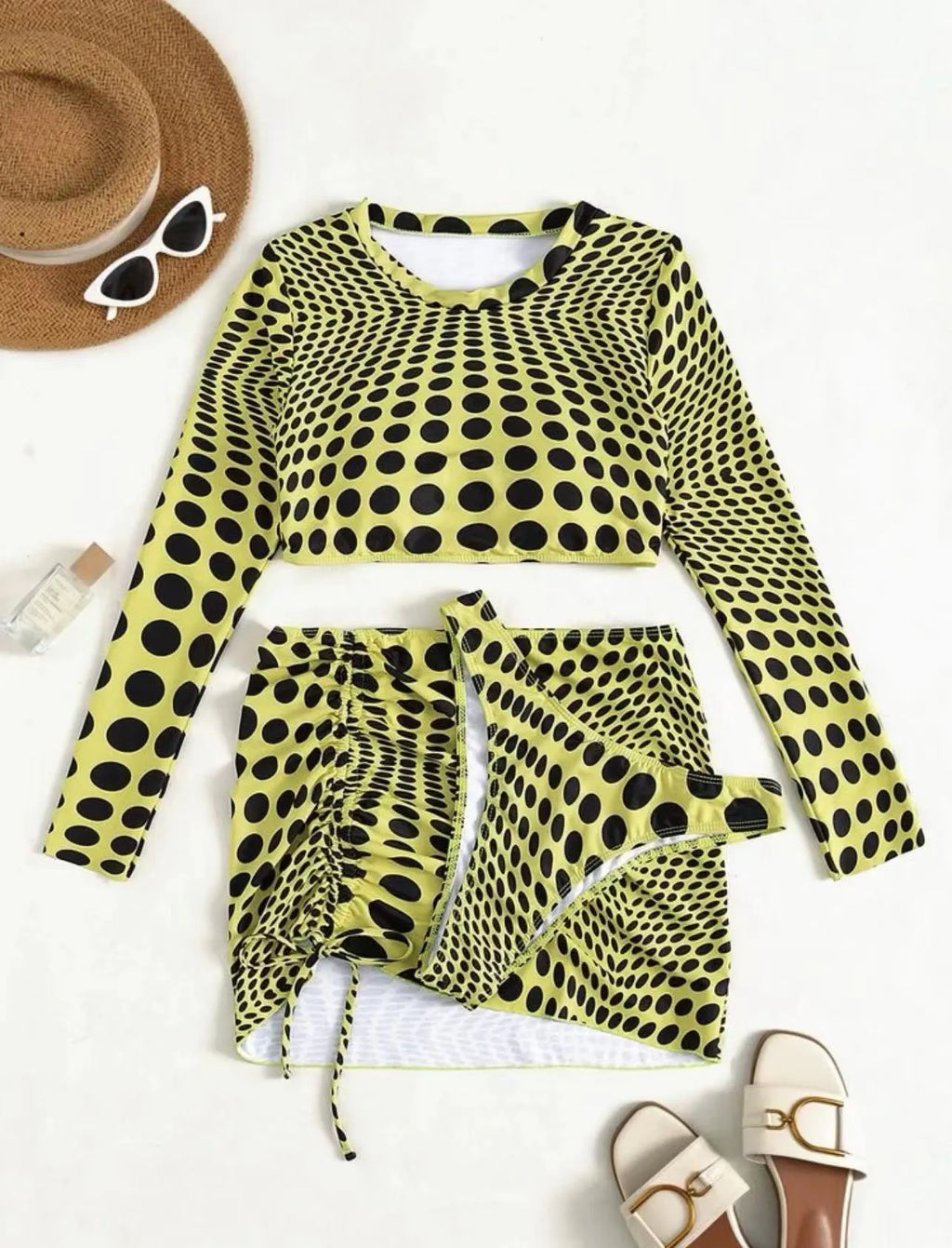 Women's green polka dot three-piece swimsuit set with halterneck bikini top and matching skirt