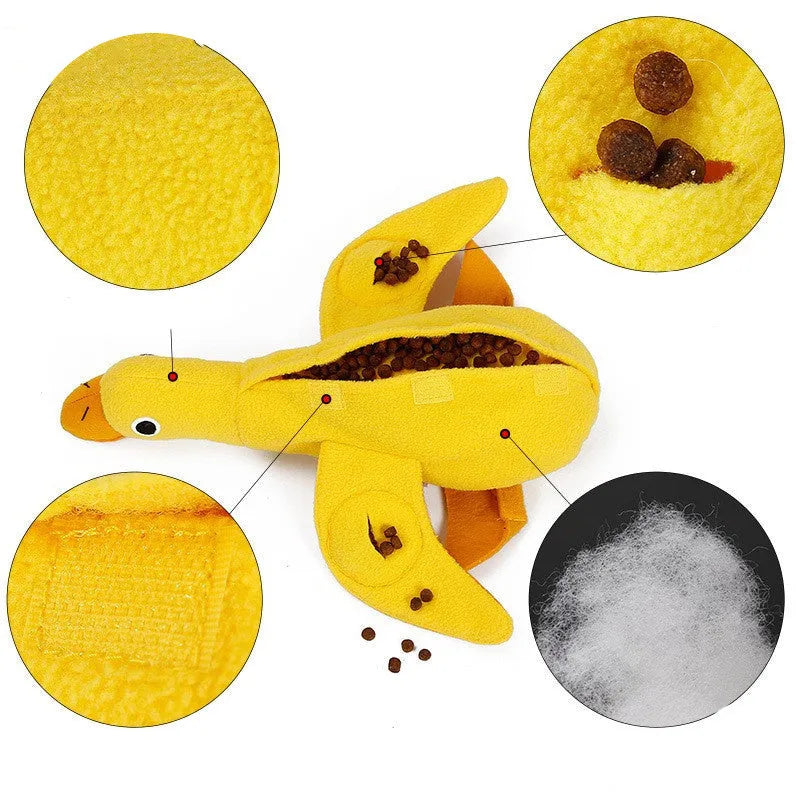 Yellow plush teddy dog toy with attached duck doll and food leak compartments for pet training