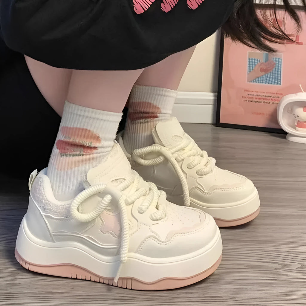 Women's green patent leather platform sneaker with round toe and white rubber sole on a pink background.