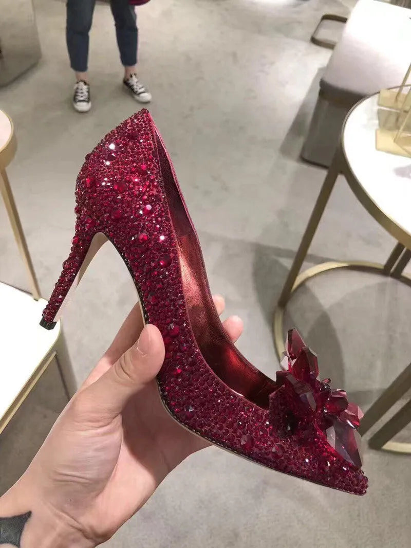 Women's gold high heel shoes with rhinestone detailing and pointed toe design