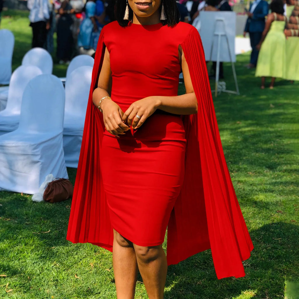 Pleated shawl style evening gown with round neck and long sleeves in formal setting