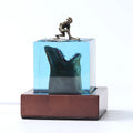 Clear epoxy resin ornament with shark surfer scene inside, shown next to a scale indicating 5cm and 8cm size options.