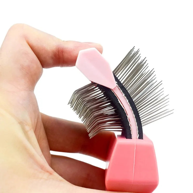 Double-sided pet grooming brush with stainless steel pins in blue or pink, showing ergonomic handle and pin details