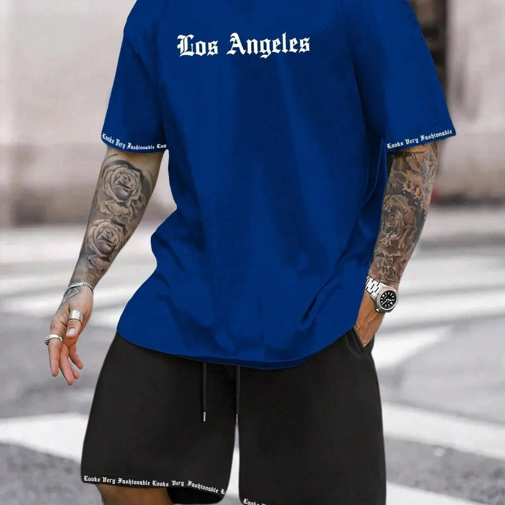 Man wearing a blue printed short-sleeved top and matching shorts from a sports-style two-piece set