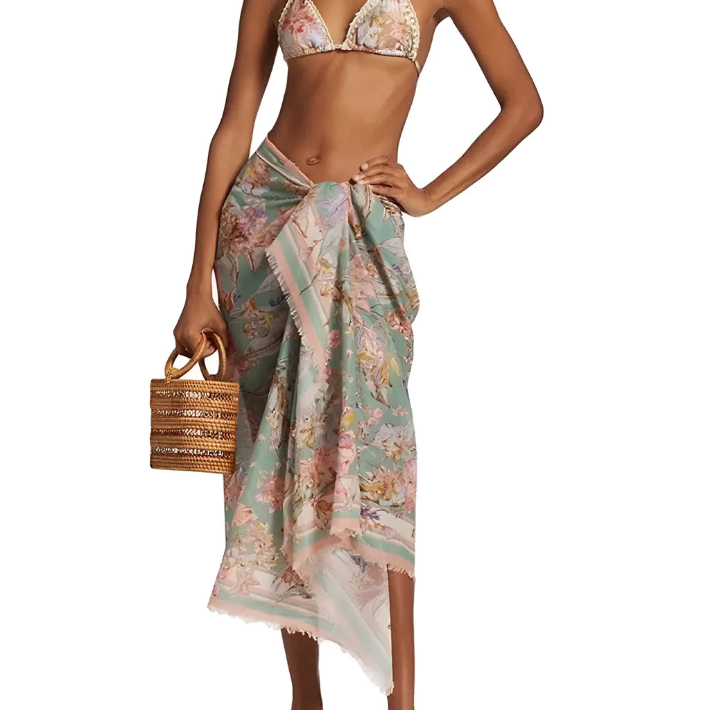 Creamy white women's floral bikini set with top, briefs, and matching skirt on a mannequin.