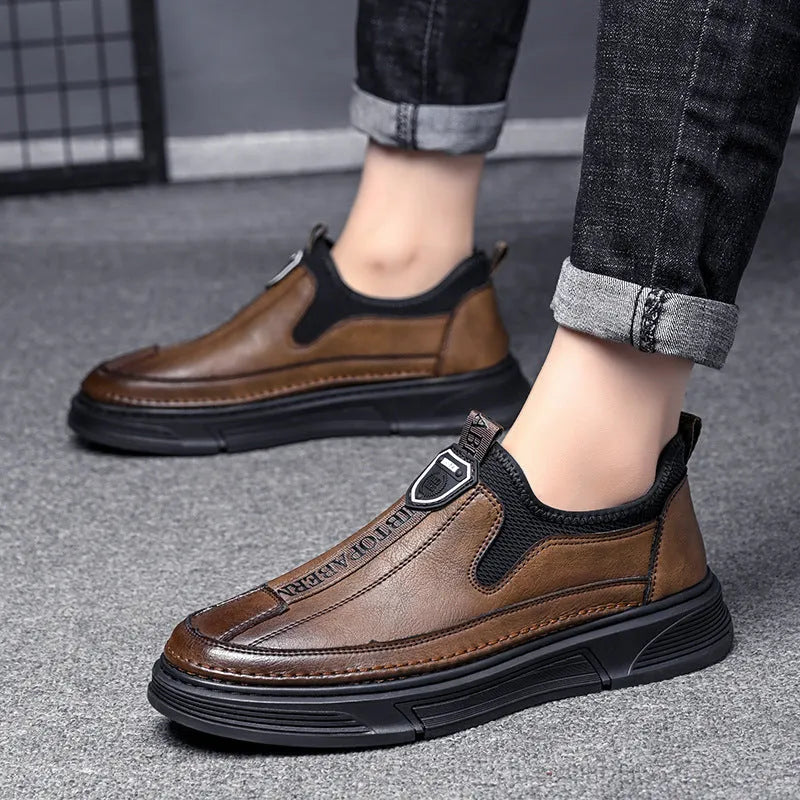 Men's black leather casual shoes with round toe design on solid colour background