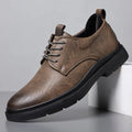 Men's black and brown breathable leather casual shoes with rubber sole and sewing line detail.